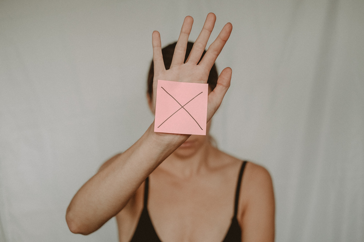 Woman showing paper with prohibition sign